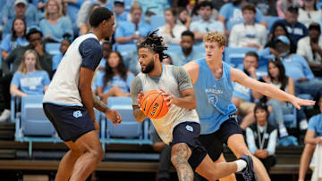 Oct 12, 2024; Chapel Hill, NC, USA;  North Carolina Tar Heels guard RJ Davis (4) with the ball as guard Cade Tyson (5) defends in the first half at the Dean E. Smith Center. Mandatory Credit: Bob Donnan-Imagn Images