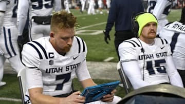 Nov 9, 2024; Pullman, Washington, USA; Utah State Aggies quarterback Spencer Petras (7) reviews plays on a tablet during a game against the Washington State Cougars in the second half at Gesa Field at Martin Stadium. Mandatory Credit: James Snook-Imagn Images