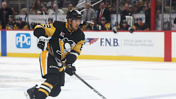 Oct 21, 2025; Pittsburgh, Pennsylvania, USA;  Pittsburgh Penguins defenseman Caleb Jones (82) handles the puck against the Vancouver Canucks during the third period at PPG Paints Arena. Mandatory Credit: Charles LeClaire-Imagn Images