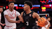 Michigan State guard Jaden Akins drives to the basket against Rutgers guard Ace Bailey