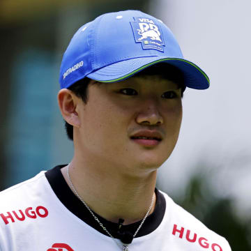 May 2, 2024; Miami Gardens, Florida, USA; RB racing driver Yuki Tsunoda (22) walks into the team village in advance of the F1 Miami Grand Prix at the Miami International Autodrome. Mandatory Credit: Peter Casey-USA TODAY Sports