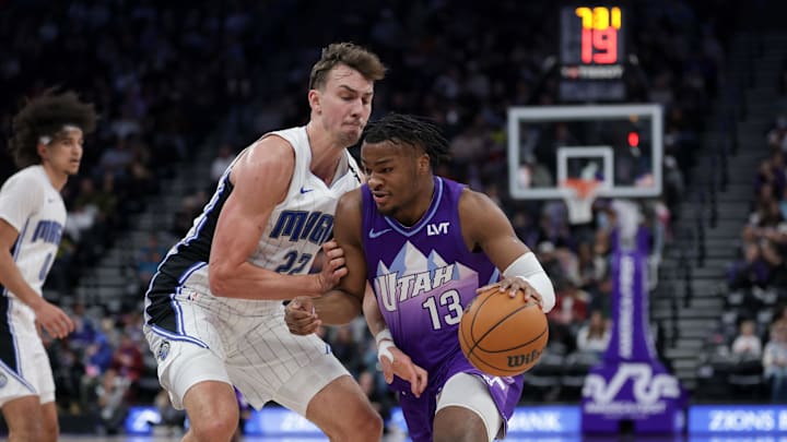Feb 1, 2025; Salt Lake City, Utah, USA;  Utah Jazz guard Isaiah Collier (13) dribbles the ball against Orlando Magic forward Franz Wagner (22) during the second half at Delta Center. Mandatory Credit: Chris Nicoll-Imagn Images