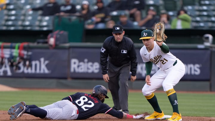 Minnesota Twins outfielder Austin Martin (82) slides back to first base against Oakland Athletics first base Tyler Soderstrom (21) during the fifth inning at Oakland-Alameda County Coliseum in Oakland, Calif., on June 21, 2024. 