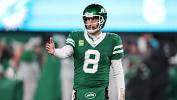 Jan 5, 2025; East Rutherford, New Jersey, USA; New York Jets quarterback Aaron Rodgers (8) gestures towards the Miami Dolphins bench during the second half at MetLife Stadium.