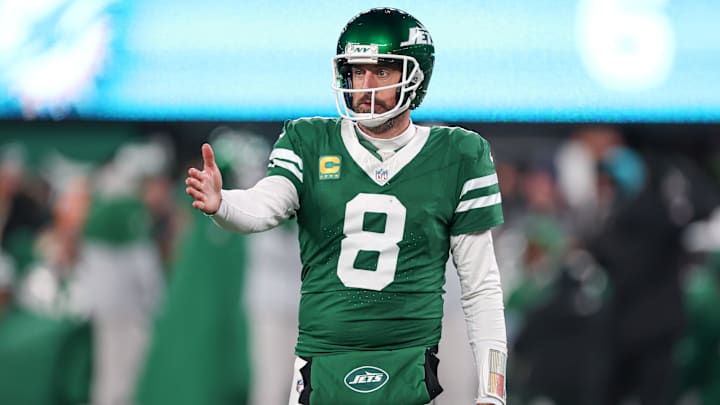 Jan 5, 2025; East Rutherford, New Jersey, USA; New York Jets quarterback Aaron Rodgers (8) gestures towards the Miami Dolphins bench during the second half at MetLife Stadium. Mandatory Credit: Vincent Carchietta-Imagn Images