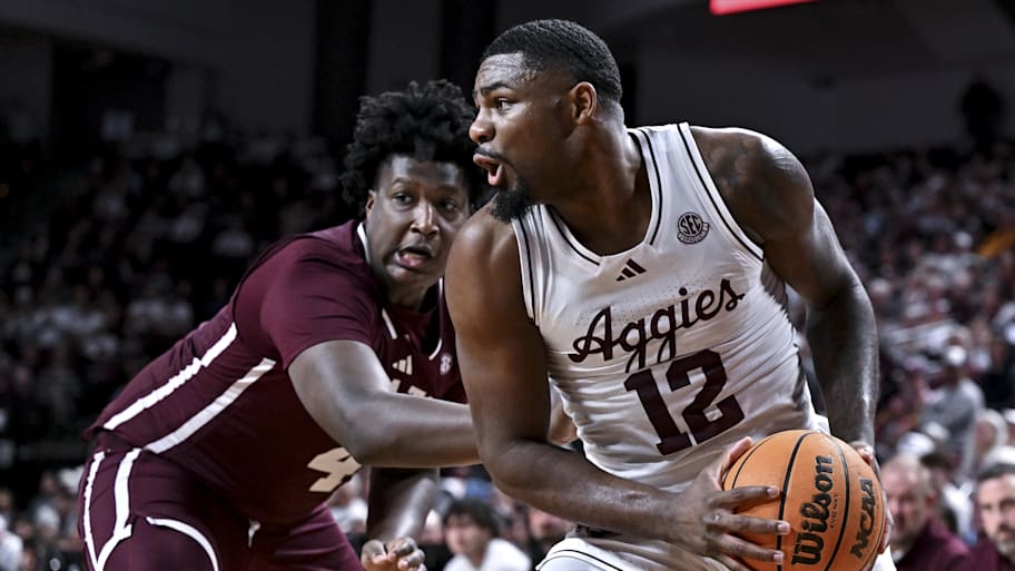Texas A&M forward Rashaun Agee looks to pass the ball as Mississippi State forward Brandon Walker defends.