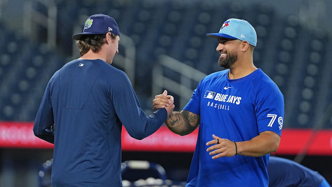 May 13, 2025; Toronto, Ontario, CAN; Tampa Bay Rays pitcher Ryan Pepiot (44) shakes hands with Toronto Blue Jays hitting coach David Popkins (79) during batting practice before a game at Rogers Centre. 