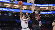 Mar 13, 2025; Charlotte, NC, USA;  Louisville Cardinals guard Chucky Hepburn (24) goes to the basket against Stanford Cardinal forward Maxime Raynaud (42) during the second half at Spectrum Center. Mandatory Credit: Jim Dedmon-Imagn Images