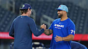 May 13, 2025; Toronto, Ontario, CAN; Tampa Bay Rays pitcher Ryan Pepiot (44) shakes hands with Toronto Blue Jays hitting coach David Popkins (79) during batting practice before a game at Rogers Centre. 