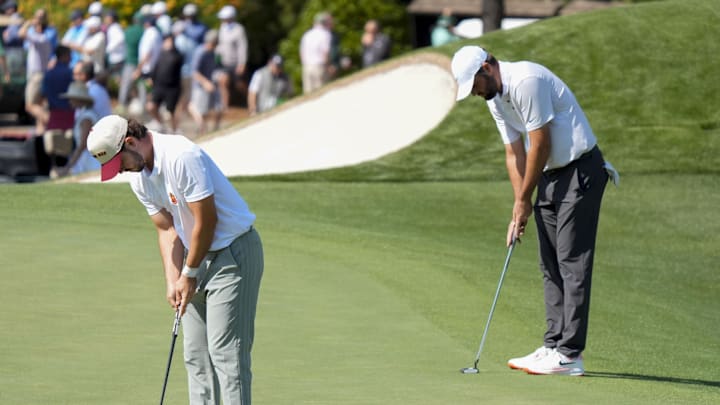 Jose Luis Ballester and Scottie Scheffler prepare to putt on no. 3 during the first round of the Masters Tournament