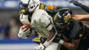 Decatur Central Hawks N'po Dodo (11) rushes away from Fort Wayne Snider Panthers Brandon Logan (4) on Friday, Nov. 24, 2023, during the IHSAA Class 3A football state championship game at Lucas Oil Stadium in Indianapolis. 