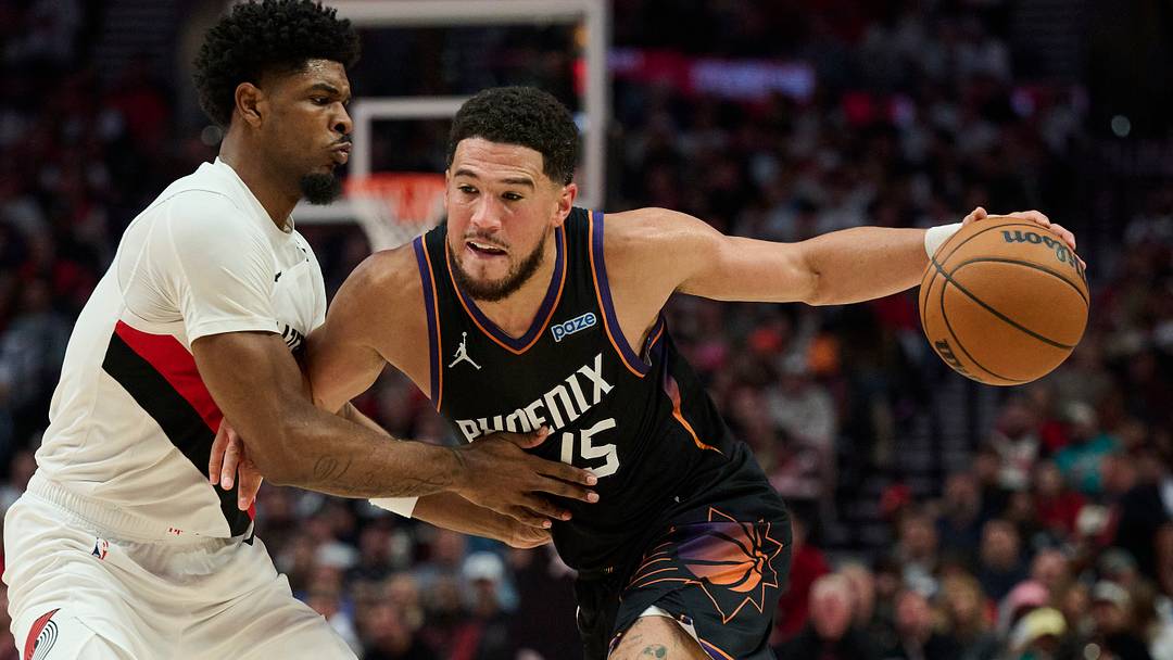 Oct 21, 2026; Portland, Oregon, USA; Phoenix Suns guard Devin Booker (15) drives to the basket during the second half against Portland Trail Blazers guard Scoot Henderson (00) at Moda Center. Mandatory Credit: Troy Wayrynen-Imagn Images