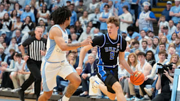 Duke Blue Devils forward Cooper Flagg dribbles as North Carolina Tar Heels guard Elliot Cadeau defends.