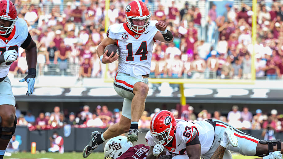Georgia quarterback  Gunner Stockton (14) runs with the ball against Mississippi State