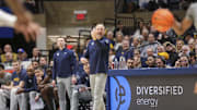 Mar 8, 2025; Morgantown, West Virginia, USA; West Virginia Mountaineers head coach Darian DeVries calls out a play during the first half against the UCF Knights at WVU Coliseum. Mandatory Credit: Ben Queen-Imagn Images
