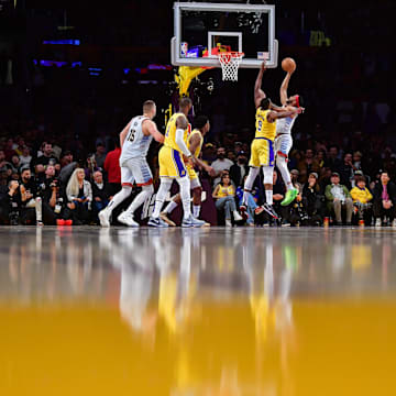 May 22, 2023; Los Angeles, California, USA; Denver Nuggets forward Bruce Brown (11) shoots the ball against Los Angeles Lakers center Tristan Thompson (9) during the fourth quarter in game four of the Western Conference Finals for the 2023 NBA playoffs at Crypto.com Arena. Mandatory Credit: Gary A. Vasquez-Imagn Images