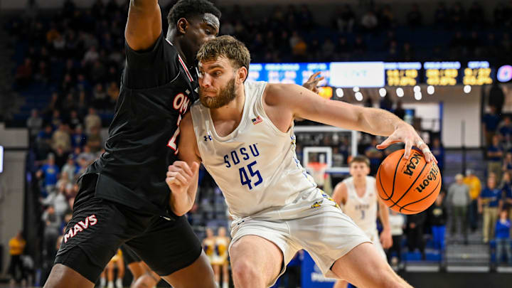 South Dakota State Jackrabbits center Oscar Cluff (45) posts up against Omaha Mavericks forward Valentino Simon (21) on Thursday, Feb. 13, 2025, at First Bank and Trust Arena in Brookings, S.D.