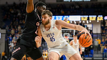 South Dakota State Jackrabbits center Oscar Cluff (45) posts up against Omaha Mavericks forward Valentino Simon (21) on Thursday, Feb. 13, 2025, at First Bank and Trust Arena in Brookings, S.D.