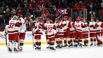 Dec 11, 2025; Washington, District of Columbia, USA; Carolina Hurricanes goaltender Brandon Bussi (32) celebrates with teammates after their game against the Washington Capitals at Capital One Arena. Mandatory Credit: Geoff Burke-Imagn Images