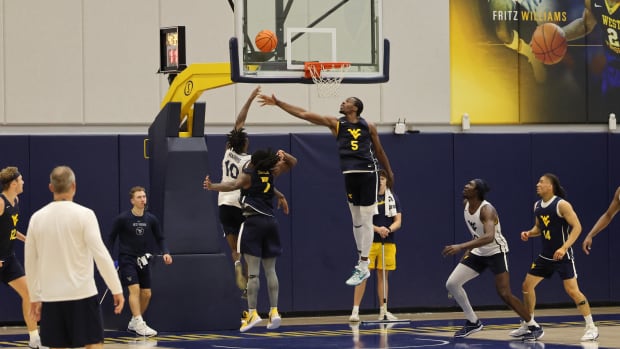 West Virginia University forward Toby Okani