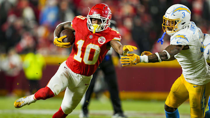 Dec 8, 2024; Kansas City, Missouri, USA; Kansas City Chiefs running back Isiah Pacheco (10) runs with the ball against Los Angeles Chargers safety Derwin James Jr. (3) during the second half at GEHA Field at Arrowhead Stadium.