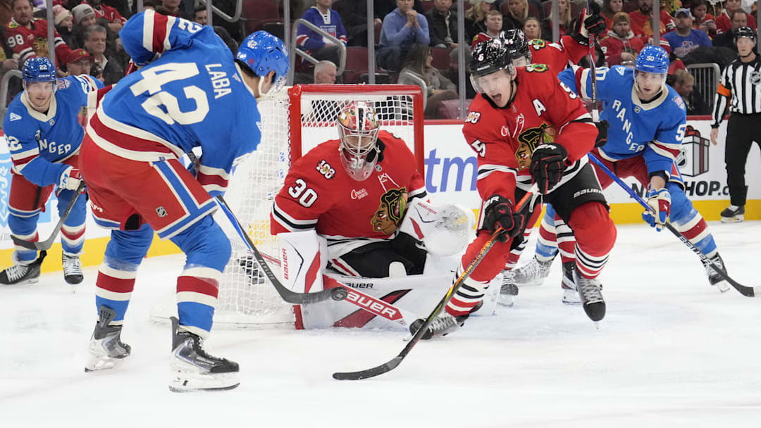 Dec 10, 2025; Chicago, Illinois, USA; New York Rangers center Noah Laba (42) shoots the puck on Chicago Blackhawks goaltender Spencer Knight (30) during the third period at United Center. Mandatory Credit: David Banks-Imagn Images