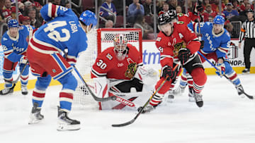Dec 10, 2025; Chicago, Illinois, USA; New York Rangers center Noah Laba (42) shoots the puck on Chicago Blackhawks goaltender Spencer Knight (30) during the third period at United Center. Mandatory Credit: David Banks-Imagn Images