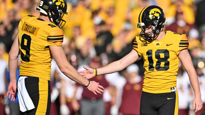 Oct 21, 2023; Iowa City, Iowa, USA; Iowa Hawkeyes place kicker Drew Stevens (18) reacts with punter Tory Taylor (9) during the game against the Minnesota Golden Gophers at Kinnick Stadium. Mandatory Credit: Jeffrey Becker-USA TODAY Sports