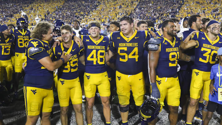 Sep 13, 2025; Morgantown, West Virginia, USA; West Virginia Mountaineers players celebrate after defeating the Pittsburgh Panthers at Milan Puskar Stadium. Mandatory Credit: Ben Queen-Imagn Images