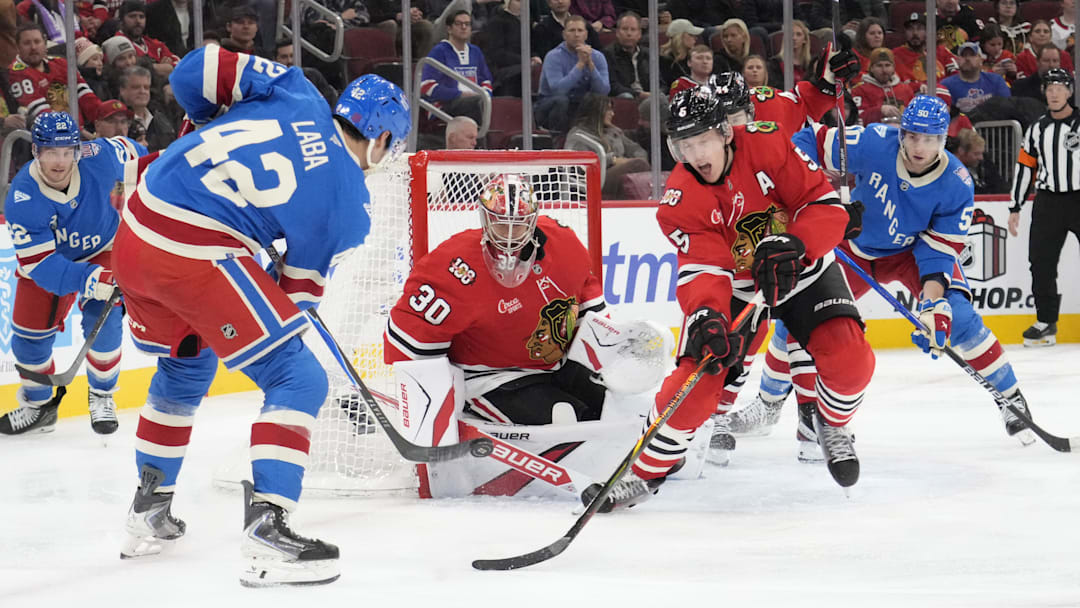 Dec 10, 2025; Chicago, Illinois, USA; New York Rangers center Noah Laba (42) shoots the puck on Chicago Blackhawks goaltender Spencer Knight (30) during the third period at United Center. Mandatory Credit: David Banks-Imagn Images