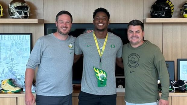 Oregon Ducks coach Dan Lanning with five-star recruit Michael Terry III. Oregon is battling the Texas Longhorns for Terry III