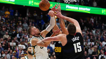 Mar 7, 2024; Denver, Colorado, USA; Boston Celtics center Kristaps Porzingis (8) and Denver Nuggets center Nikola Jokic (15)