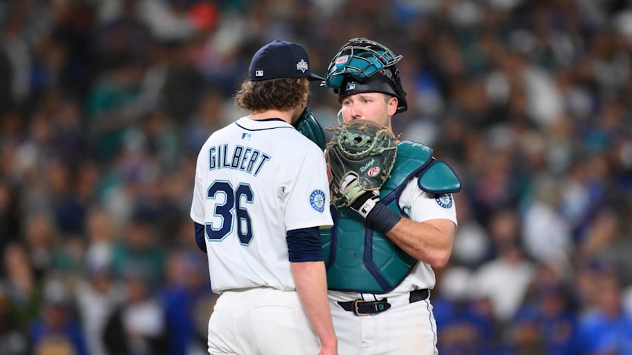 Seattle Mariners catcher Cal Raleigh talks with pitcher Logan Gilbert during the eleventh inning