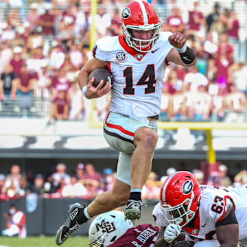 Nov 8, 2025; Starkville, Mississippi, USA; Georgia Bulldogs quarterback  Gunner Stockton (14) runs with the ball against the Mississippi State Bulldogs during the first half at Davis Wade Stadium at Scott Field. Mandatory Credit: Wesley Hale-Imagn Images