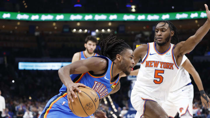 Dec 27, 2023; Oklahoma City, Oklahoma, USA; Oklahoma City Thunder guard Cason Wallace (22) drives to the basket beside New York Knicks guard Immanuel Quickley (5) during the second half at Paycom Center. Mandatory Credit: Alonzo Adams-USA TODAY Sports