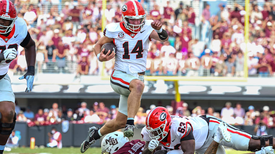 Georgia quarterback Gunner Stockton jumps while running the ball against Mississippi State.
