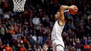 Mar 2, 2024; Blacksburg, Virginia, USA; Virginia Tech Hokies center Lynn Kidd (15) dunks the ball against Wake Forest Demon Deacons forward Andrew Carr (11) during the second half at Cassell Coliseum. Mandatory Credit: Peter Casey-Imagn Images