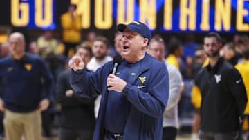 Feb 19, 2025; Morgantown, West Virginia, USA; West Virginia Mountaineers head football coach Rich Rodriguez speaks to the crowd during a timeout during the first half against the Cincinnati Bearcats at WVU Coliseum. Mandatory Credit: Ben Queen-Imagn Images