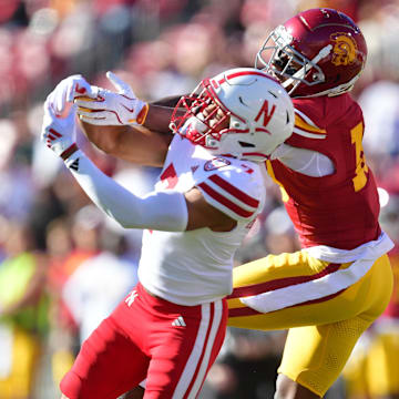 Nov 16, 2024; Los Angeles, California, USA; Nebraska Cornhuskers defensive back Malcolm Hartzog Jr. (7) breaks up a pass intended for Southern California Trojans wide receiver Kyron Hudson (10) during the first half at the Los Angeles Memorial Coliseum. 