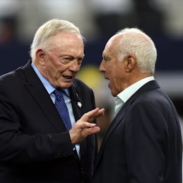 Dallas Cowboys owner Jerry Jones talks to Philadelphia Eagles owner Jeffrey Lurie before a game.