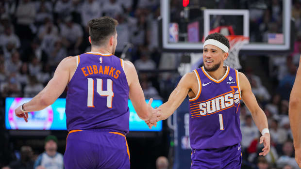 Apr 23, 2024; Minneapolis, Minnesota, USA; Phoenix Suns guard Devin Booker (1) celebrates with forward Drew Eubanks (14) against the Minnesota Timberwolves in the second quarter during game two of the first round for the 2024 NBA playoffs at Target Center. Mandatory Credit: Brad Rempel-USA TODAY Sports