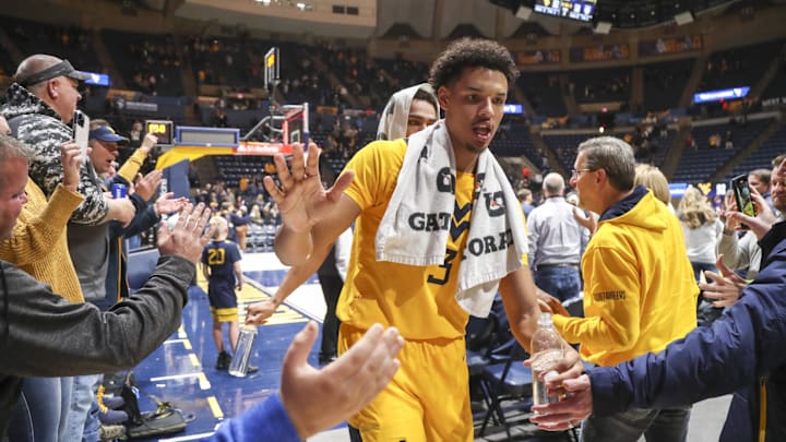 Nov 18, 2022; Morgantown, West Virginia, USA; West Virginia Mountaineers forward Tre Mitchell (3) celebrates with fans after defeating the Pennsylvania Quakers at WVU Coliseum. Mandatory Credit: Ben Queen-Imagn Images