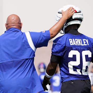 Jul 26, 2023; East Rutherford, NJ, USA; New York Giants head coach Brian Daboll pats running back Saquon Barkley (26) on the head on the first day of training camp at the Quest Diagnostics Training Facility.  