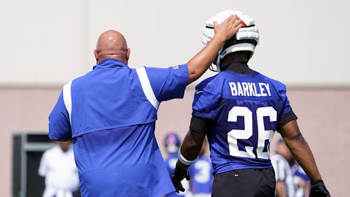 Jul 26, 2023; East Rutherford, NJ, USA; New York Giants head coach Brian Daboll pats running back Saquon Barkley (26) on the head on the first day of training camp at the Quest Diagnostics Training Facility.  