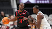 Dec 21, 2024; San Jose, California, USA; San Diego State Aztecs forward Jared Coleman-Jones (31) dribbles against California Golden Bears center Mady Sissoko (right) during the second half at SAP Center. Mandatory Credit: Darren Yamashita-Imagn Images