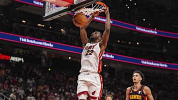 Apr 18, 2025; Atlanta, Georgia, USA; Miami Heat forward Andrew Wiggins (22) dunks behind Atlanta Hawks forward Zaccharie Risacher (10) during the second half at State Farm Arena. Mandatory Credit: Dale Zanine-Imagn Images