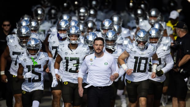  Jan 1, 2024; Glendale, AZ, USA; Oregon Ducks head coach Dan Lanning celebrates with the trophy after defeating the Liberty F