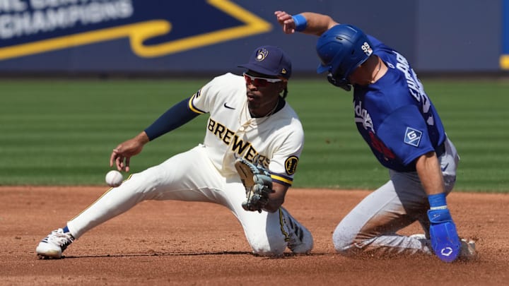 Mar 9, 2026; Phoenix, Arizona, USA; Los Angeles Dodgers outfielder Zach Ehrhard (99) steals second base under the tag by Milwaukee Brewers second baseman Greg Jones (70) in the second inning at American Family Fields of Phoenix. Mandatory Credit: Rick Scuteri-Imagn Images