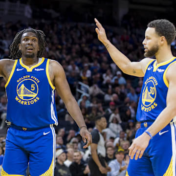  Golden State Warriors forward Andrew Wiggins (22) and guard Kevon Looney (5) and guard Stephen Curry (30) react after drawing a foul against the Denver Nuggets during the first half at Chase Center. Mandatory Credit: John Hefti-Imagn Images