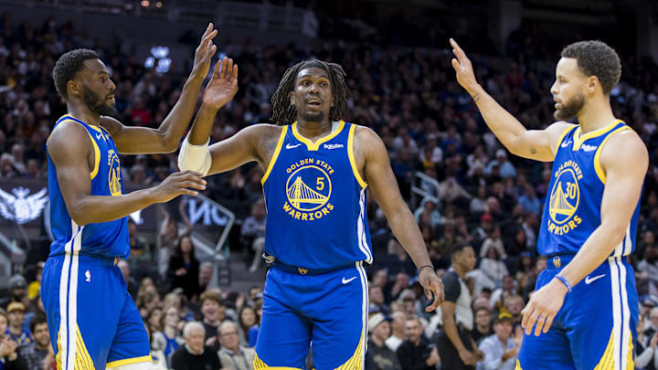  Golden State Warriors forward Andrew Wiggins (22) and guard Kevon Looney (5) and guard Stephen Curry (30) react after drawing a foul against the Denver Nuggets during the first half at Chase Center. Mandatory Credit: John Hefti-Imagn Images